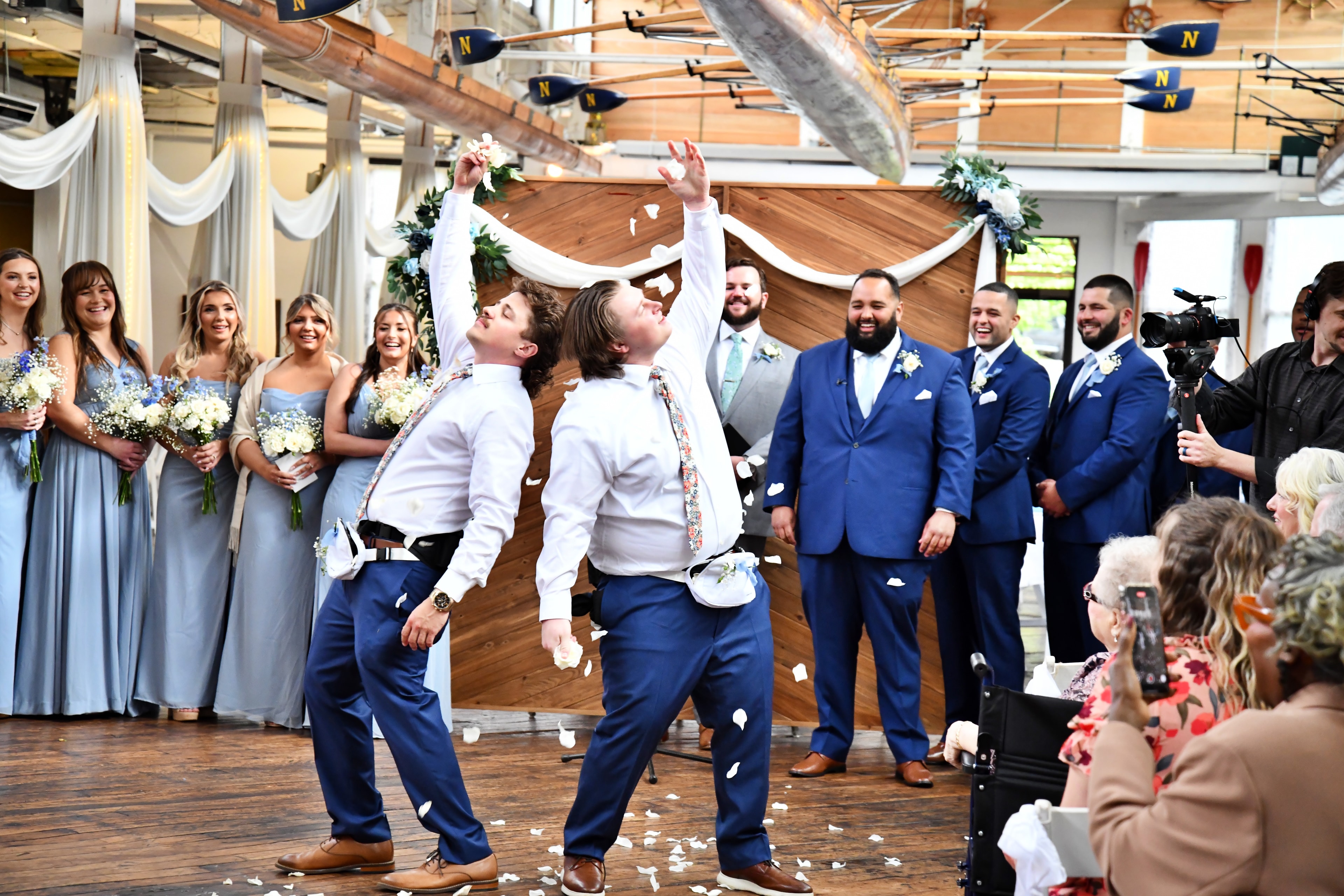 Wedding party flower boys tossing petals at ceremony